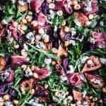 Caramelized Fig & Prosciutto Salad with hazelnuts, basil, blue cheese and arugula. Overhead shot. Up close.