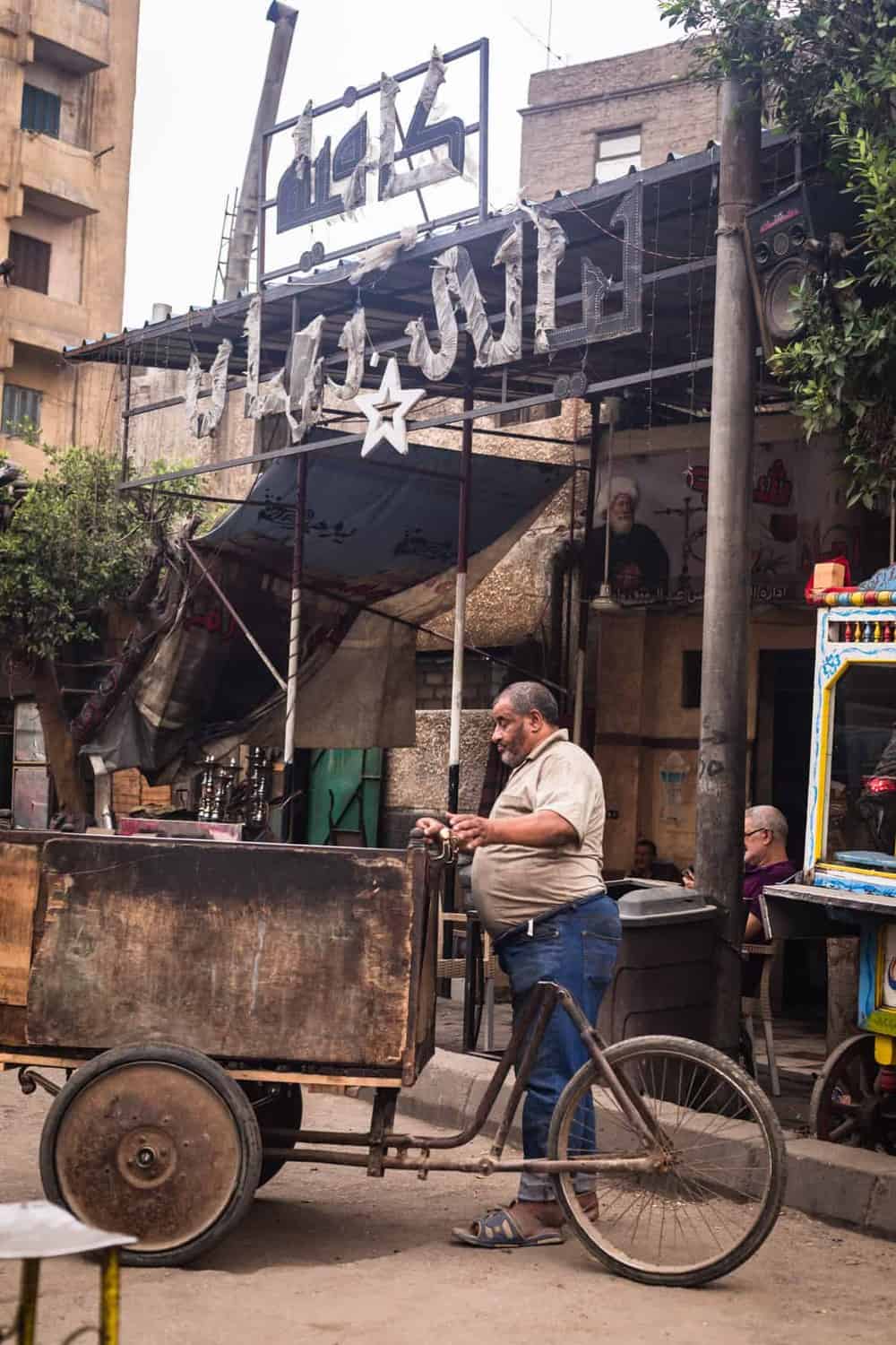 Man with a bicycle cart contraption right outside the gates of Old Cairo.