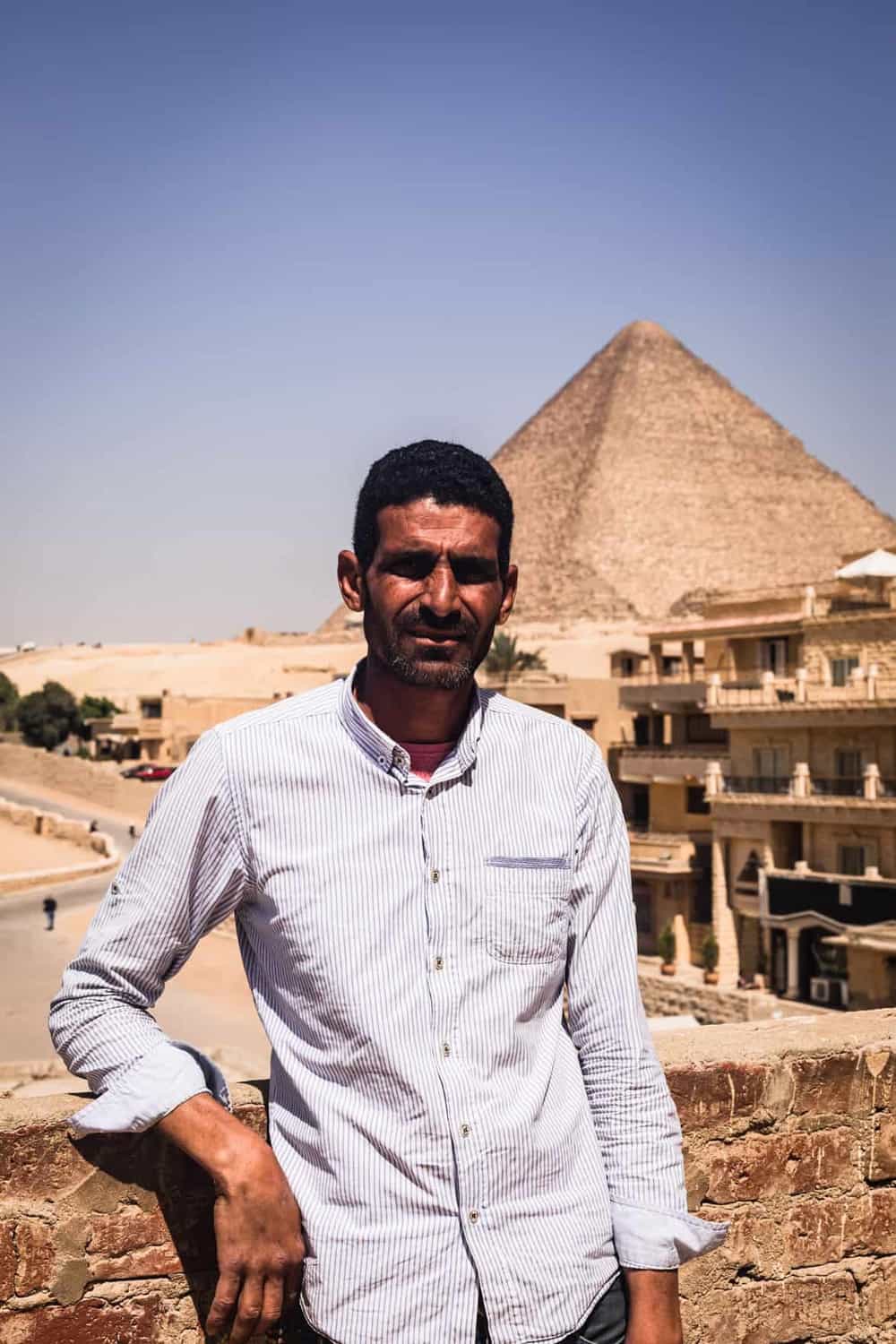 Portrait shot of my Giza tour guide, in front of the Great Pyramids.