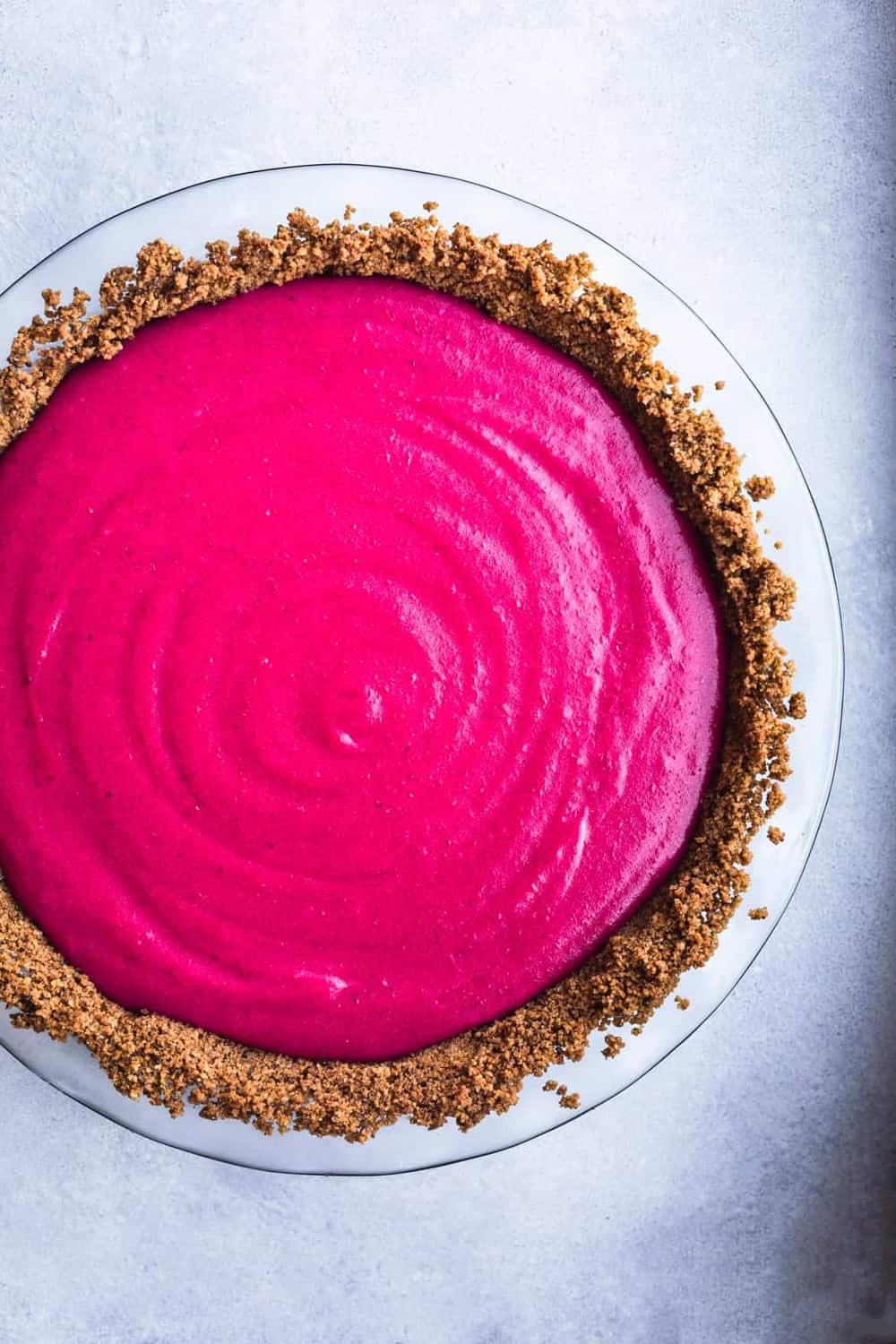 Cranberry Gingersnap Pie without any toppings. Overhead shot on a white background.