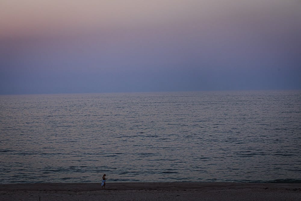 A solo lady walking at dusk in the Hamptons