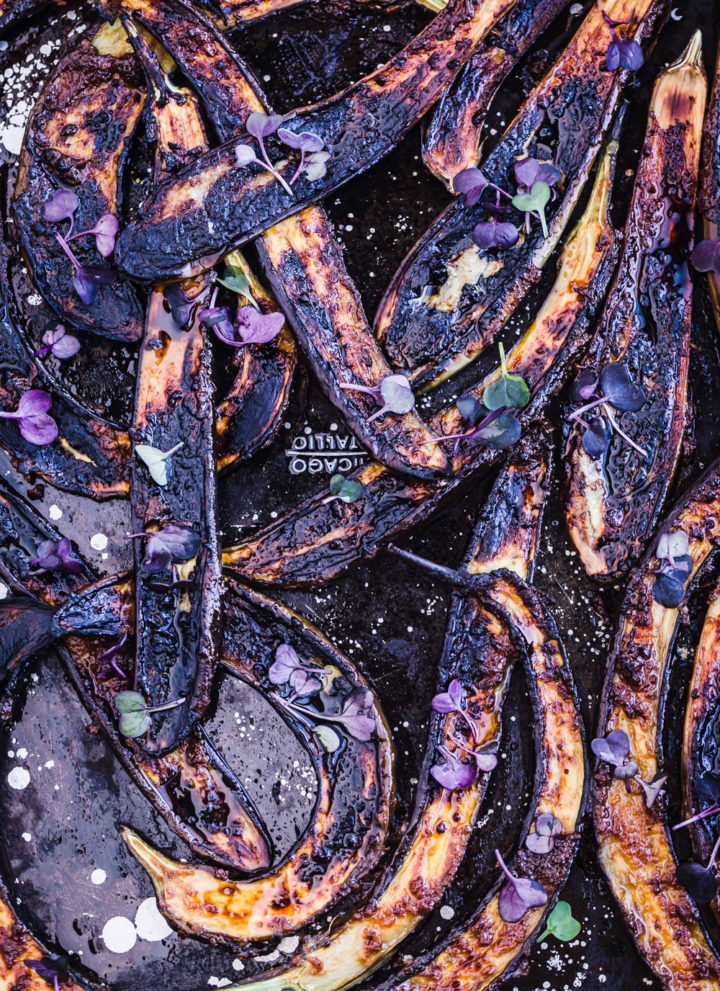 Up close and overhead shot of charred ginger-miso glazed eggplant.