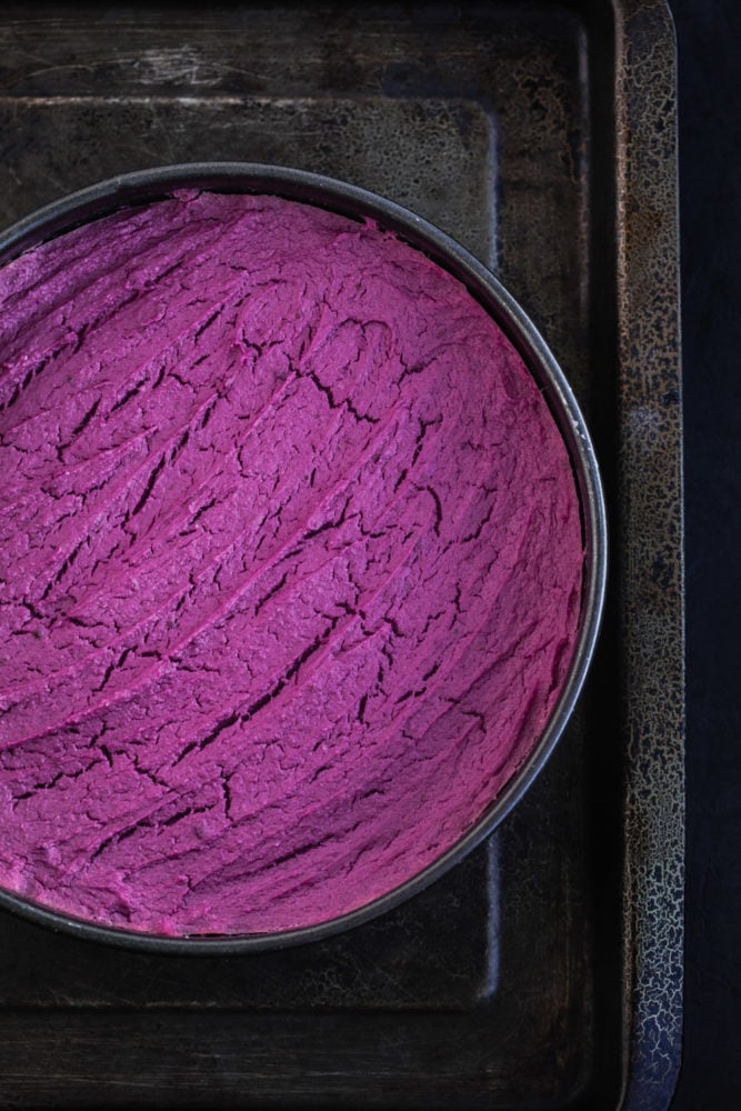 Purple sweet potato cheesecake, just out of the oven, overhead shot.