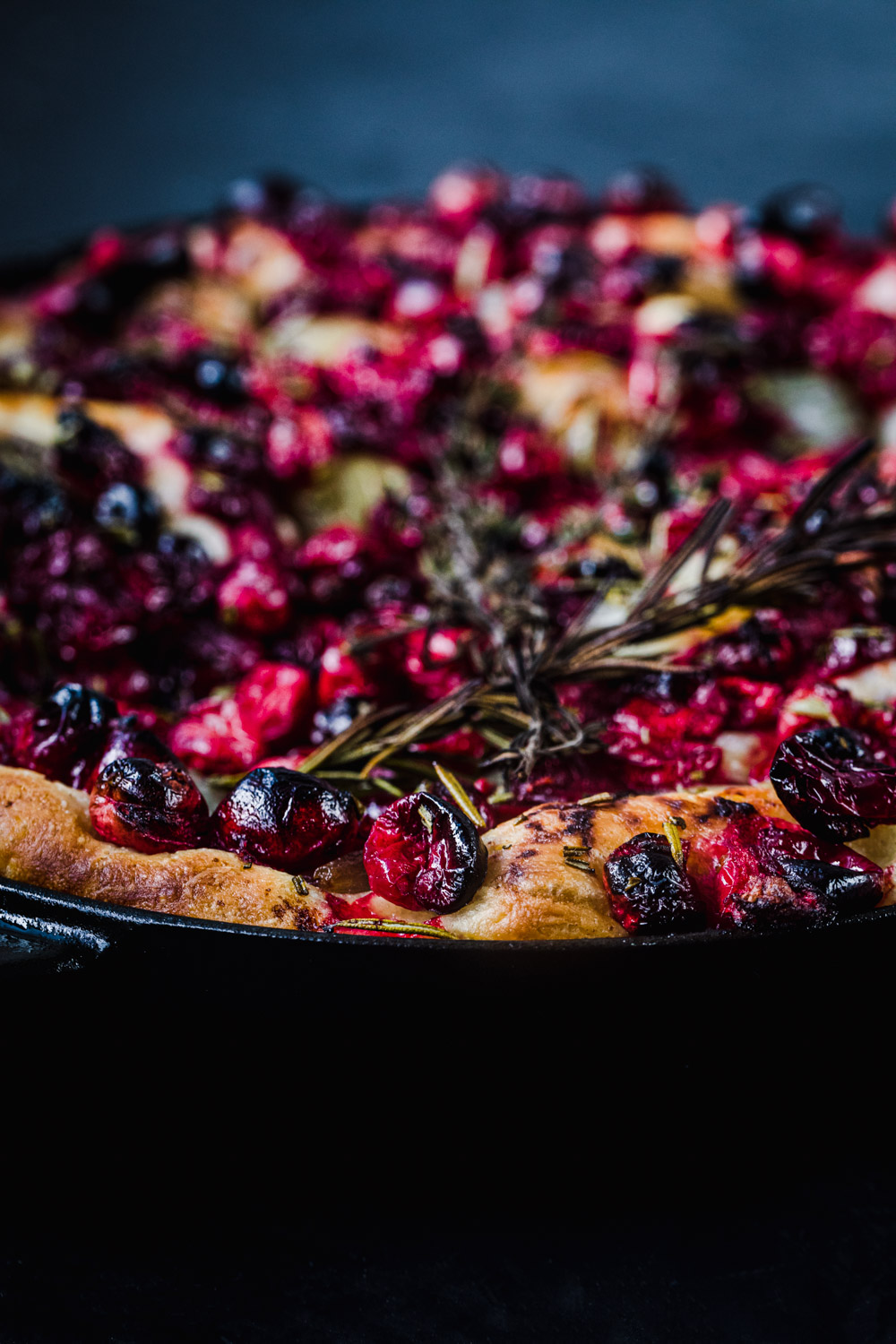 Side angle shot of Rosemary Cranberry Focaccia with Caramelized Shallots, just out of the oven.