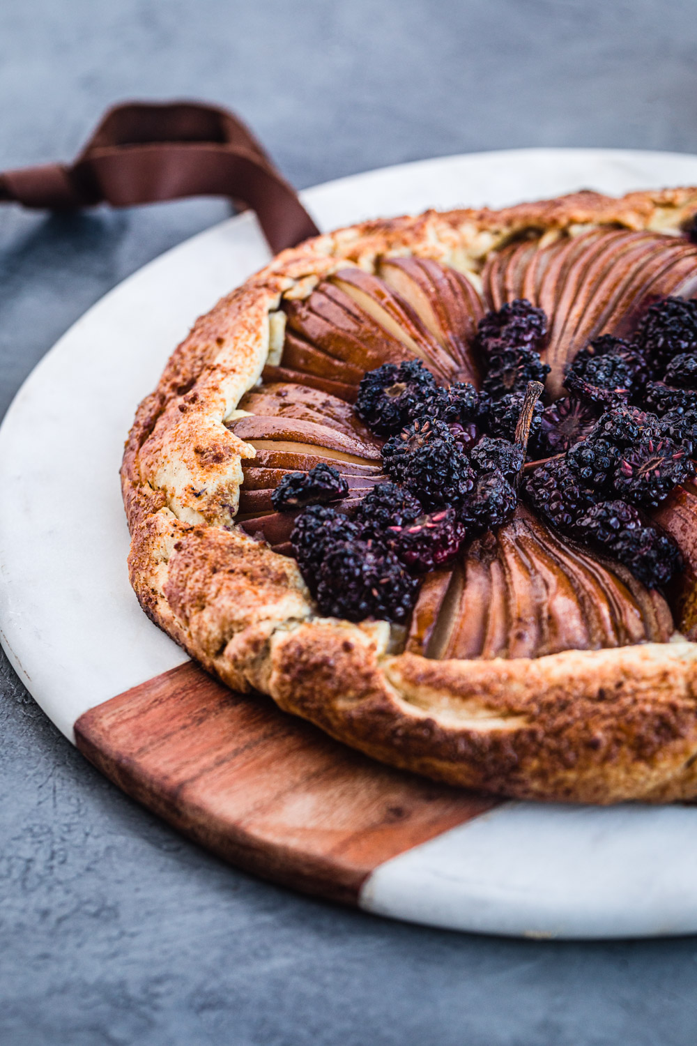 pear and blackberry galette with vanilla cream cheese, side angle shot.