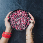 Chef Daniela Gerson holding a bowl filled with sugared cranberries.