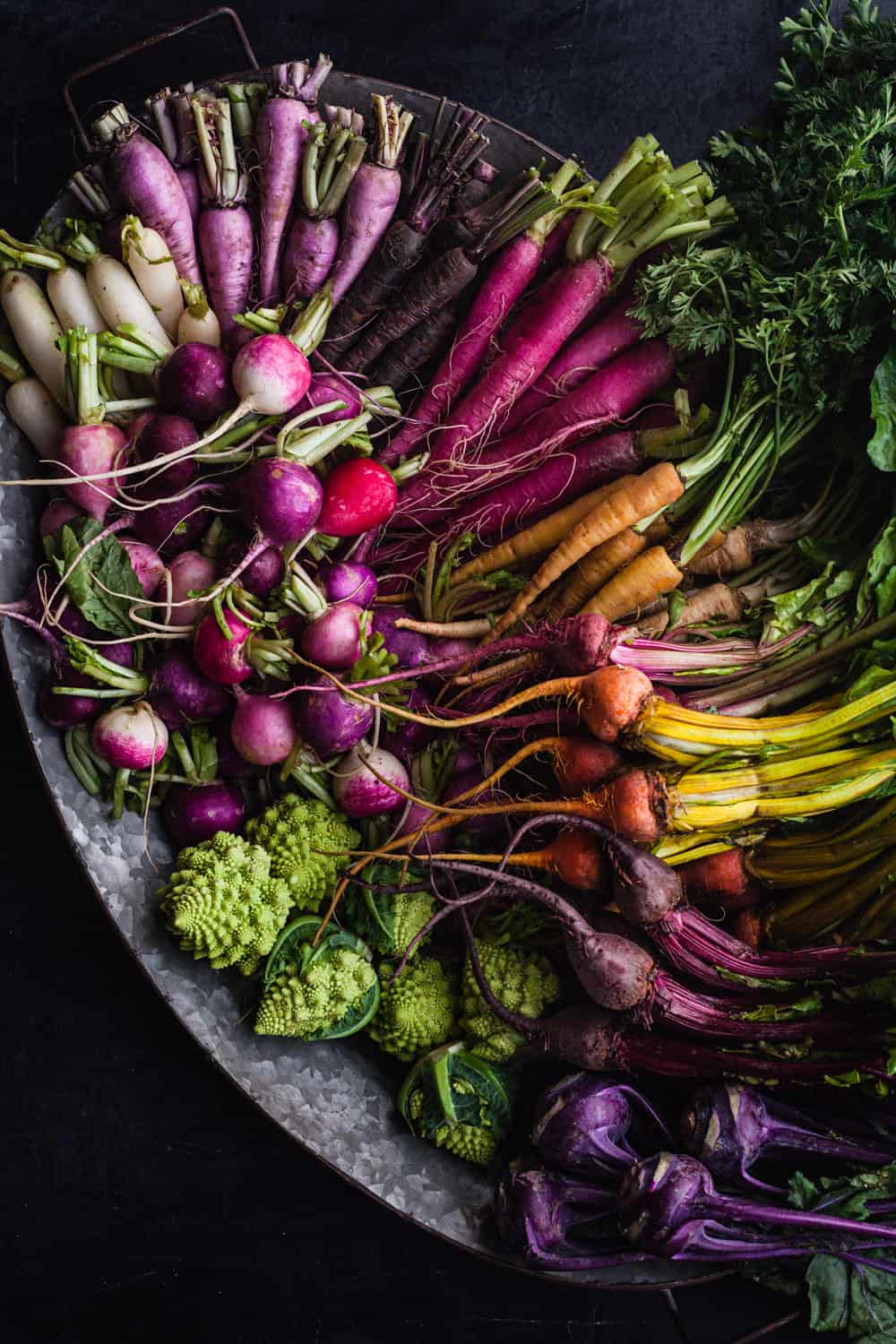 Platter filled with rainbow baby sized root veggies; radishes, beets, kohlrabi, carrots and Romanesco.