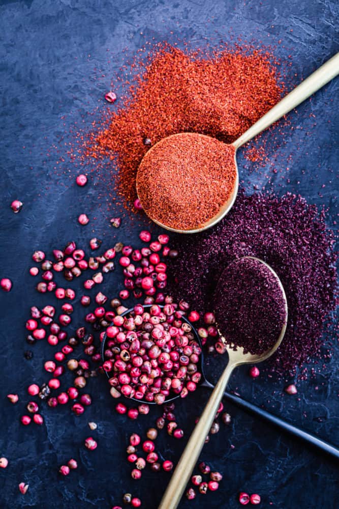ingredient shot of sumac, paprika and pink peppercorns