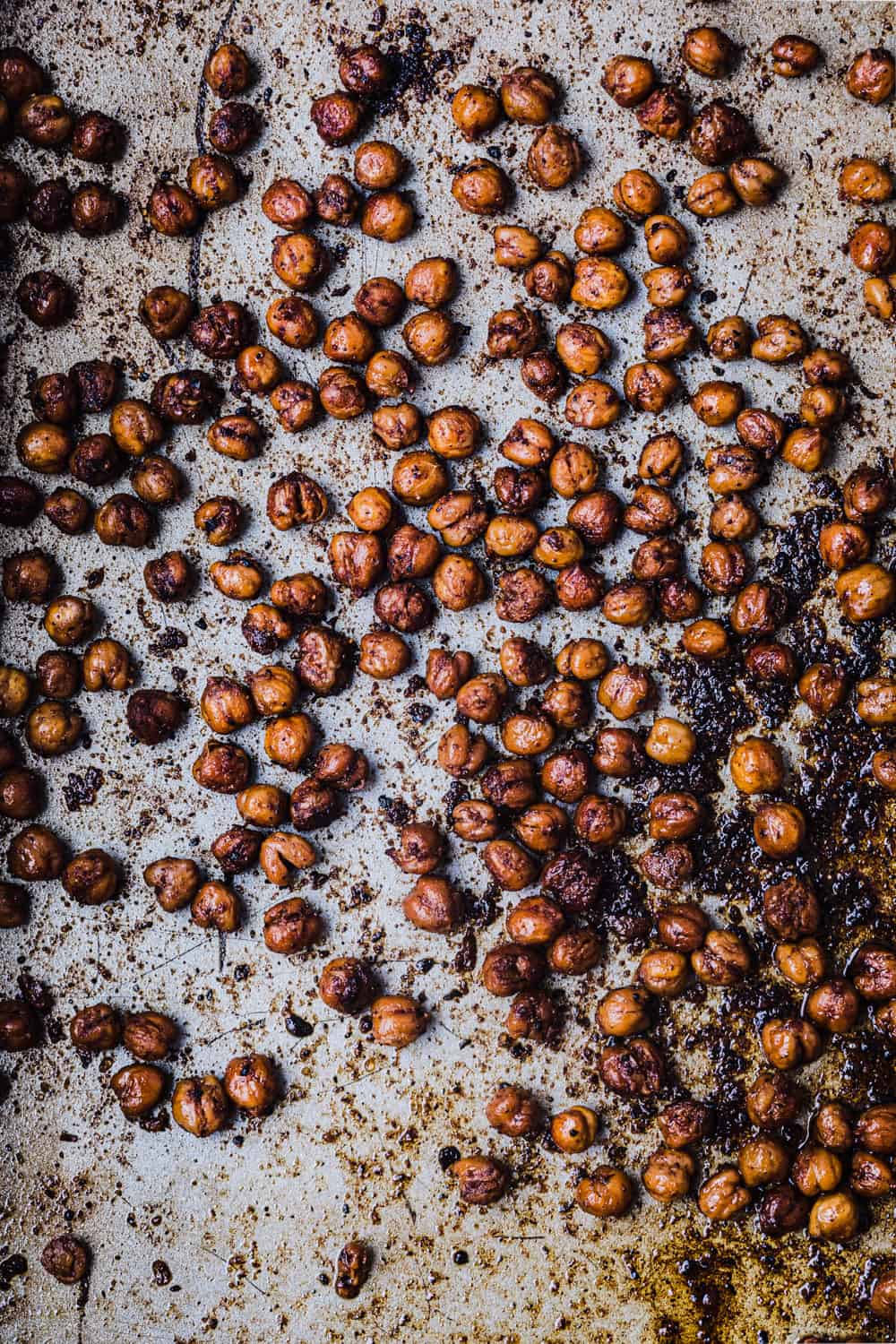 post oven shot of the chickpeas with cumin, smoked paprika, urfa chili, sumac, salt and olive oil; on a cookie sheet and ready to be eaten.