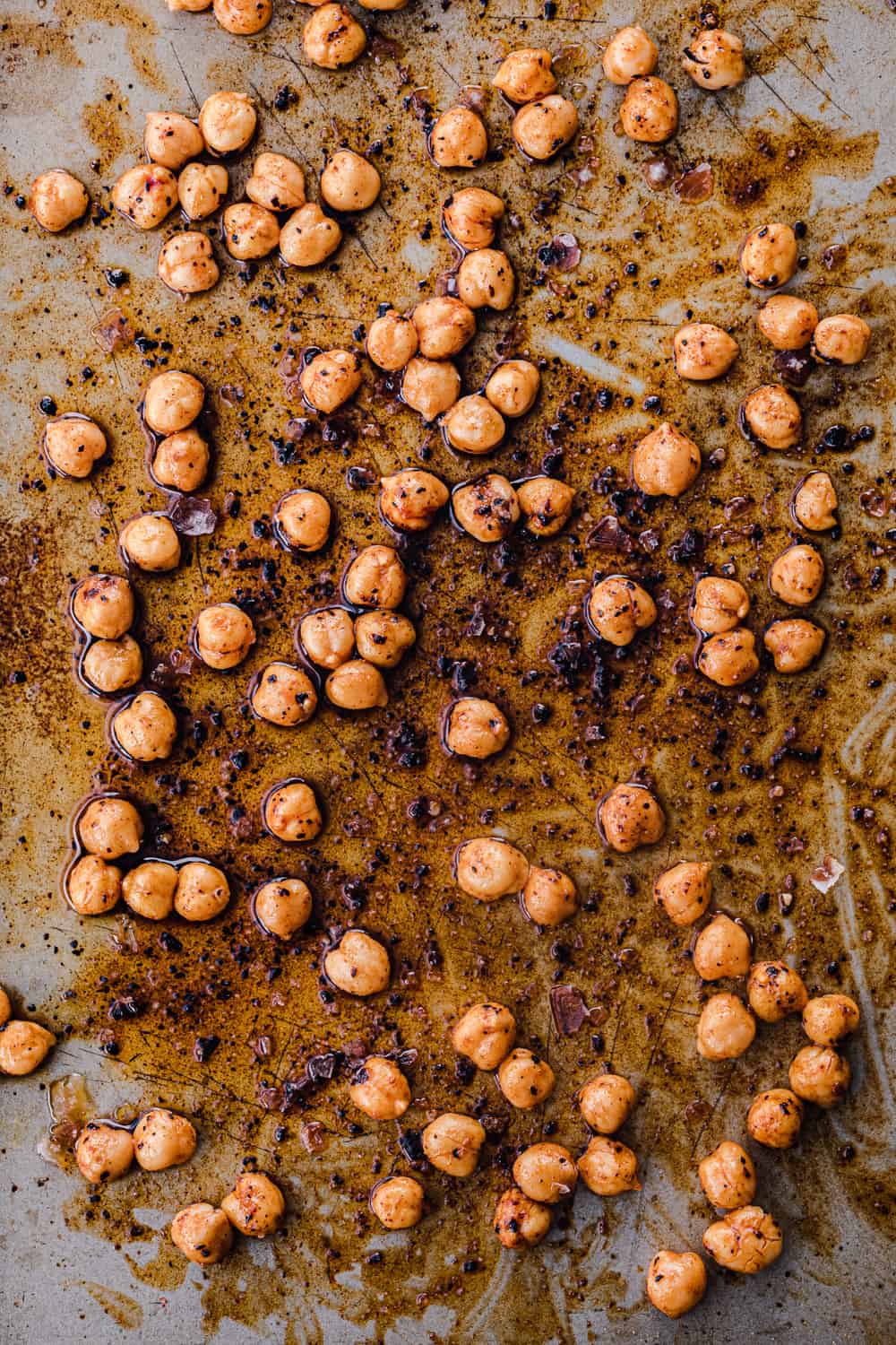 chickpeas with all sorts of spices tossed with olive oil, on a cookie sheet, pre-oven