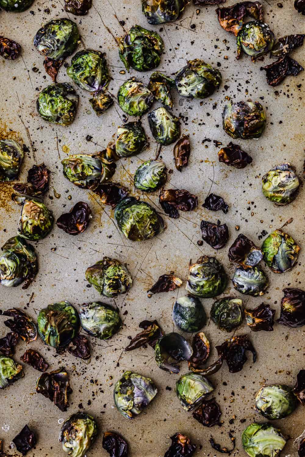 Roasted Purple Brussels sprouts just out of the oven! They turned a bit blue and are on a gold(ish) baking sheet; overhead shot.