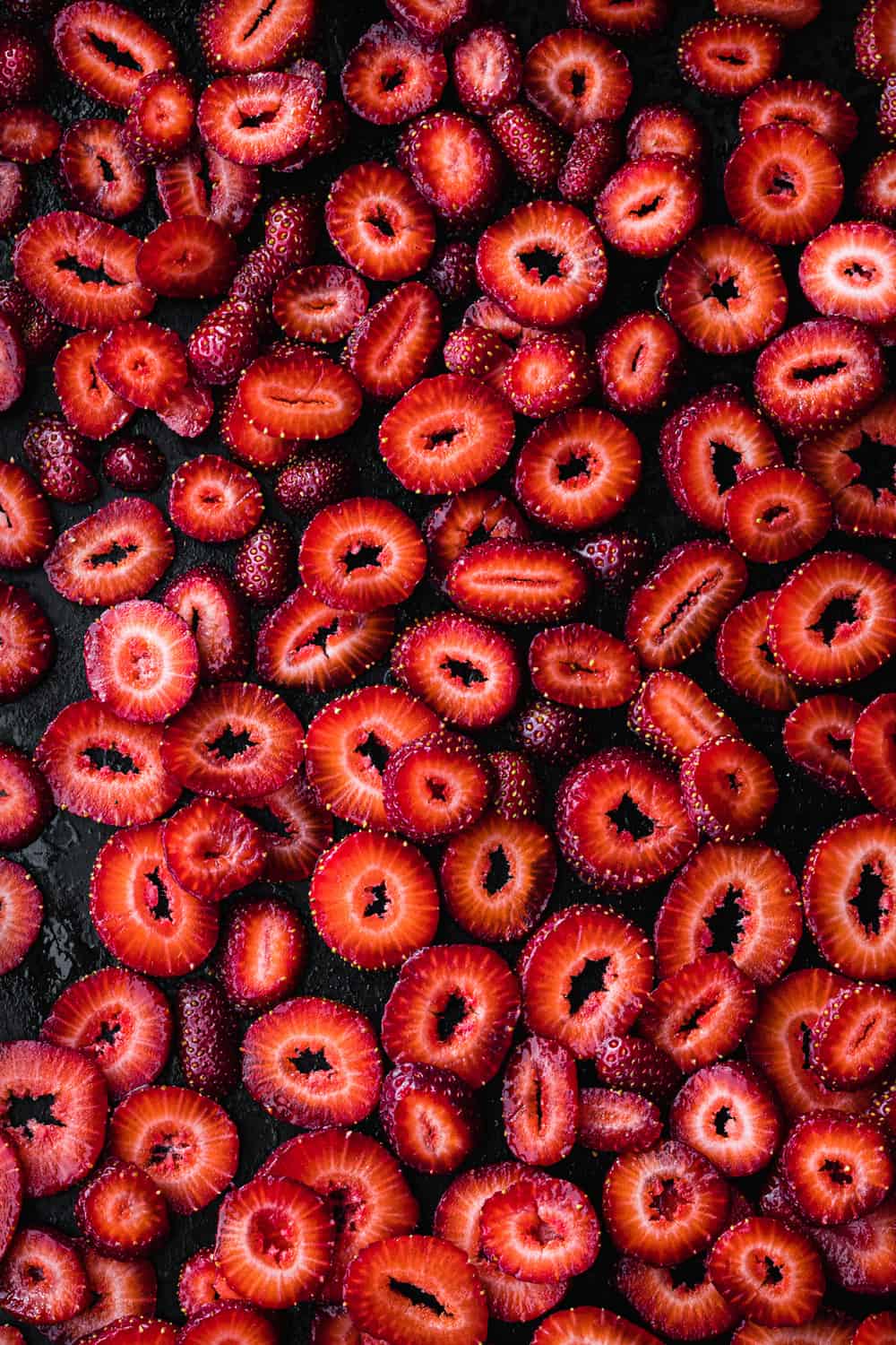 Up close and overhead shot of freshly sliced strawberries.