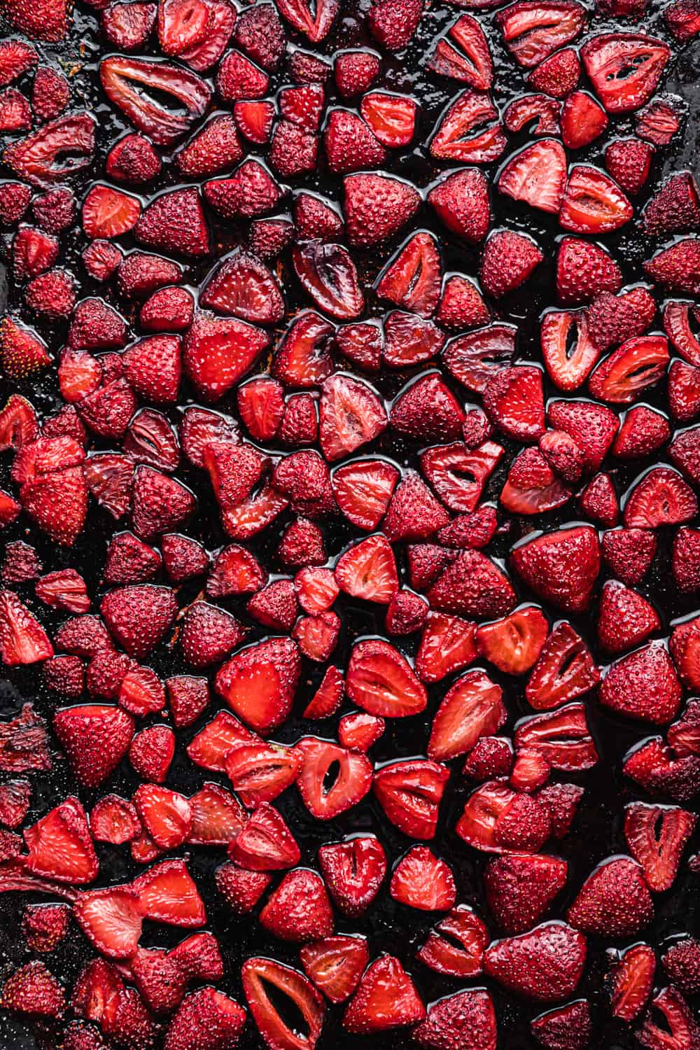 roasted strawberries on a baking sheet; overhead shot.