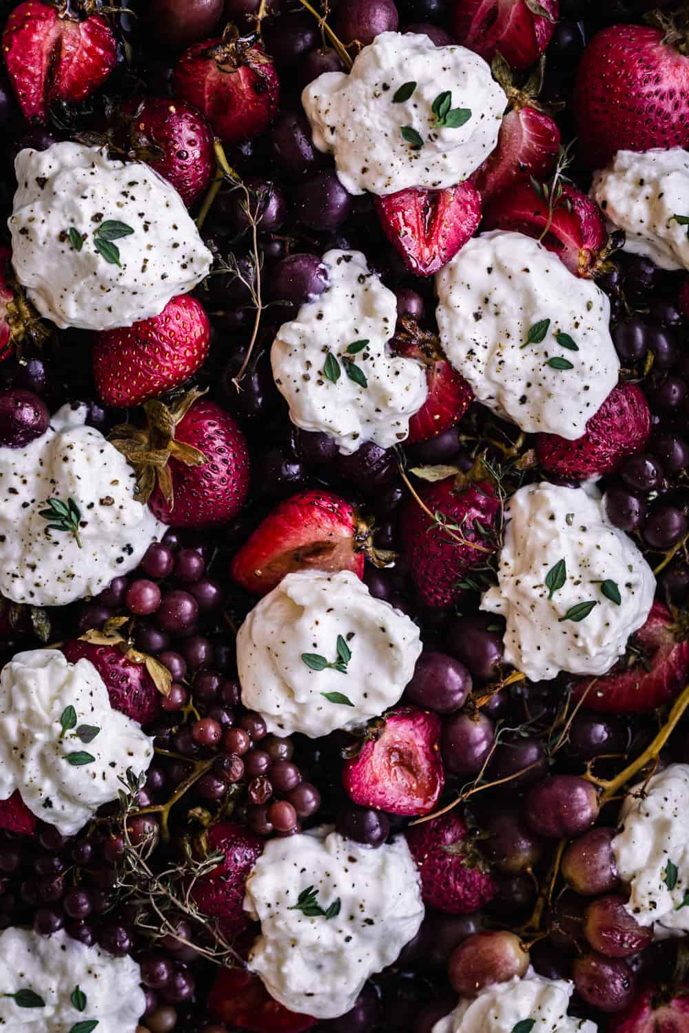 balsamic and thyme roasted grapes and strawberries topped with burrata; overhead shot