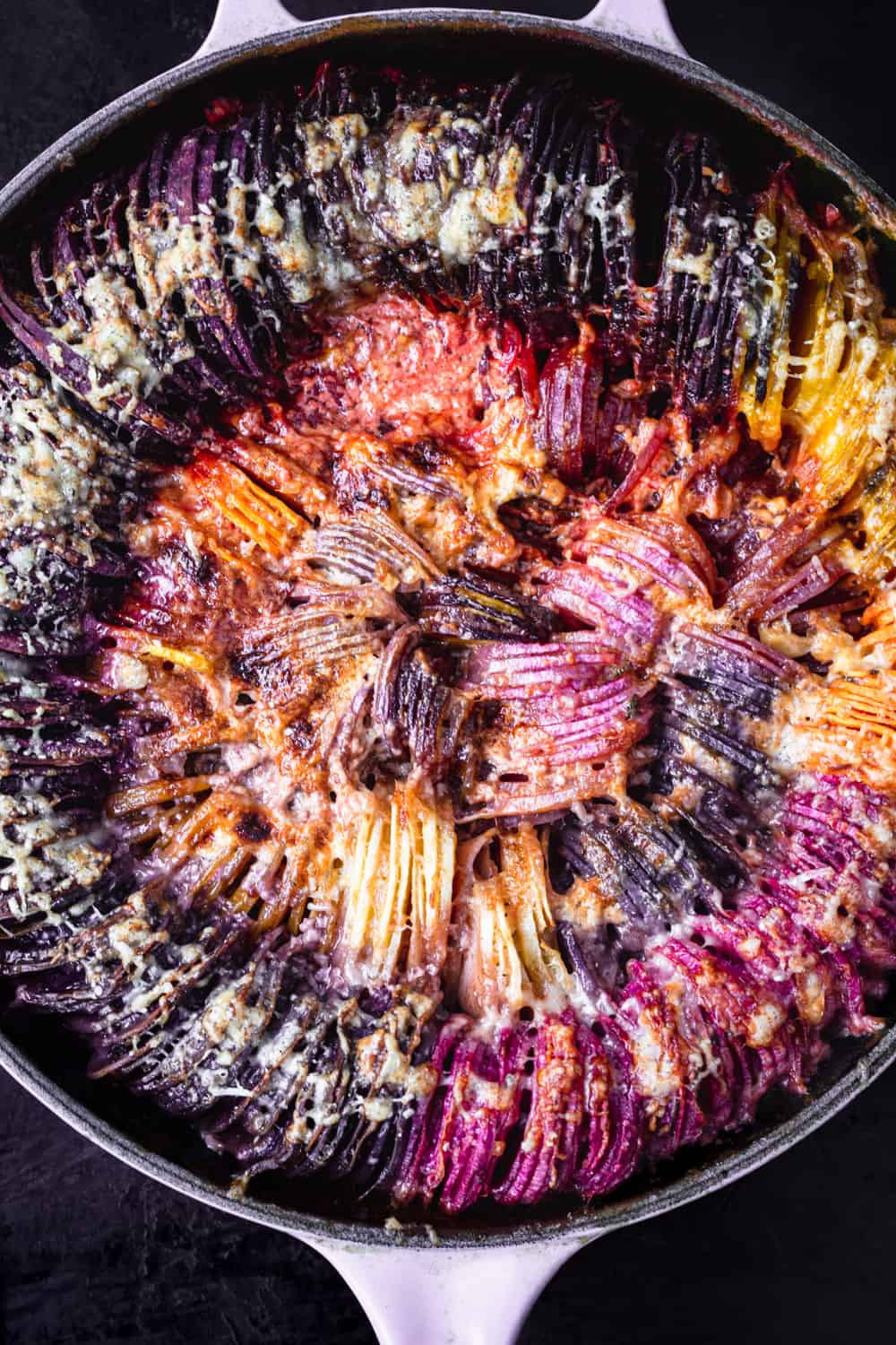 Rainbow root veggie hasselback gratin; there's purple, red, orange, yellow and white root veggies; post oven and overhead shot.