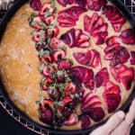 Daniela Gerson's hands the olive olive and fresh strawberry cake, overhead shot.