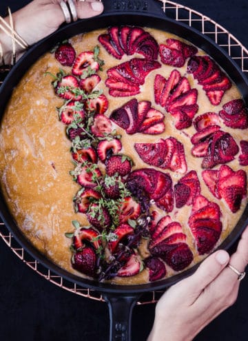 Daniela Gerson's hands the olive olive and fresh strawberry cake, overhead shot.