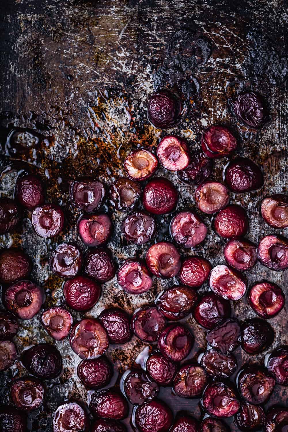 Roasted pitted cherries, on a cookie sheet, straight out of the oven.