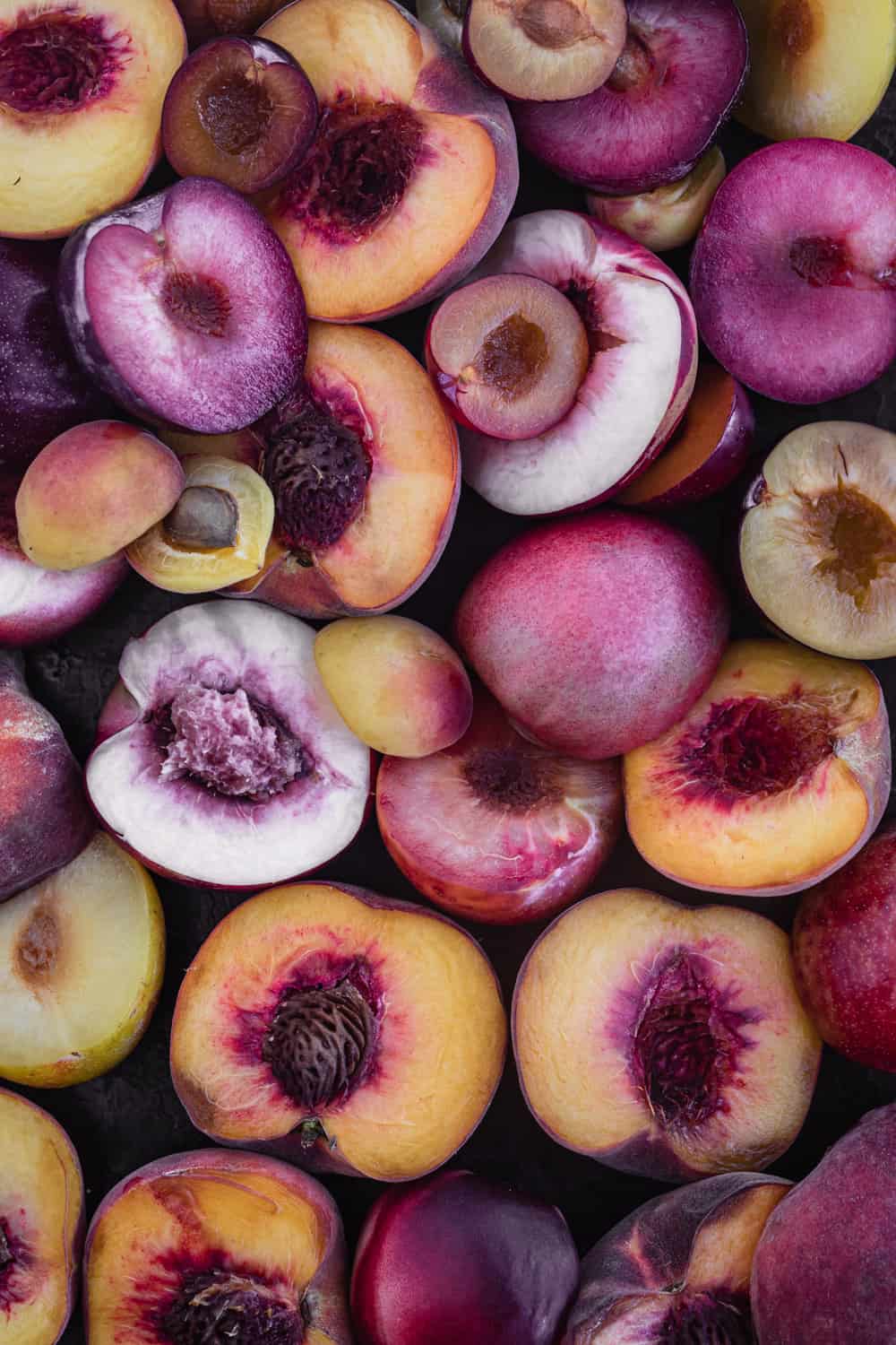 Peaches, nectarines and plums cut in half; overhead shot.