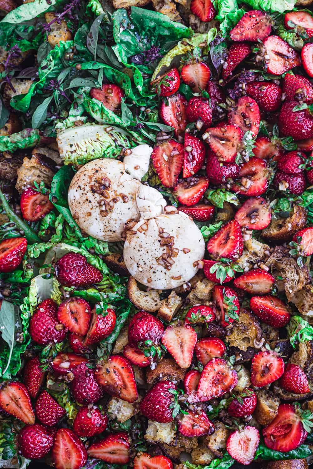 strawberry burrata salad with little gems and basil; overhead shot