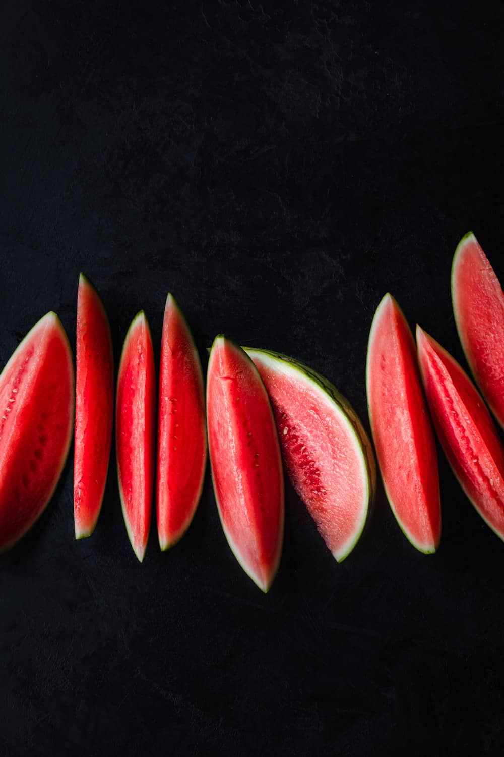 red watermelon slices on a black background