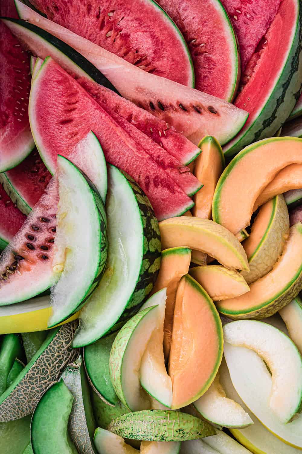 red, pink, orange, white and green melon slices