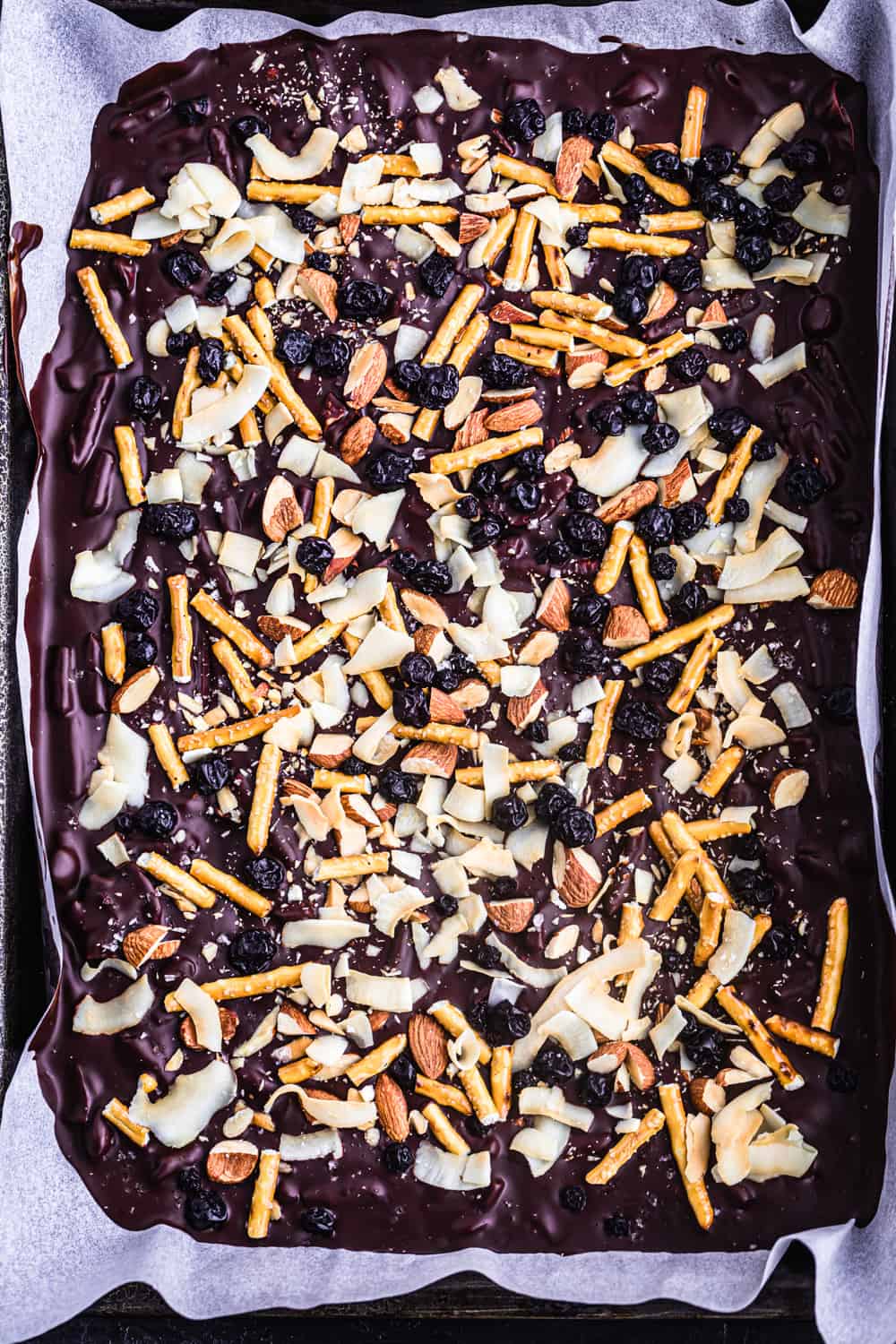 Chocolate bark with shredded coconut, pretzels, almonds and dried blueberries.