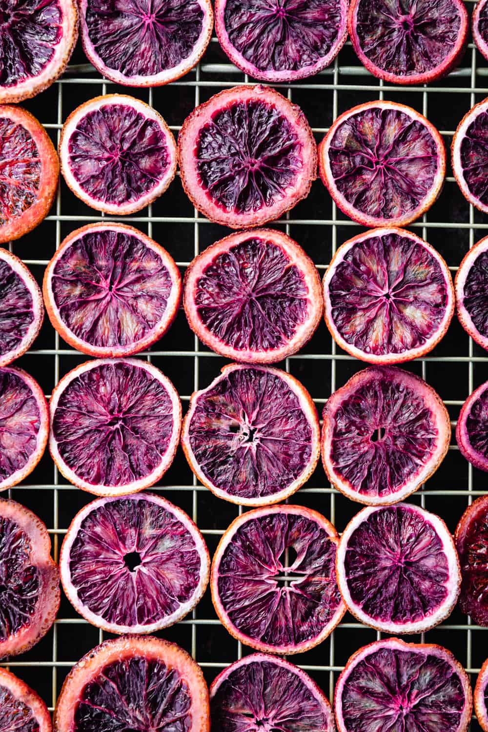 blood oranges slices drying on a gold wire rack